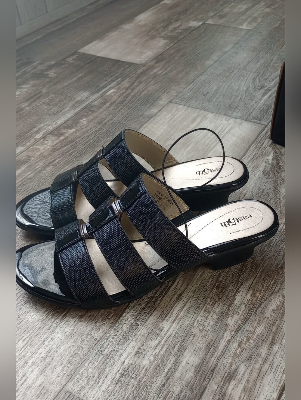 East 5th black leather sandals with silver buckle detail. Size US 10